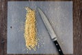 ChefÃ¢â¬â¢s knife and a pile of chopped raw walnuts on a plastic cutting mat, ready for baking Royalty Free Stock Photo